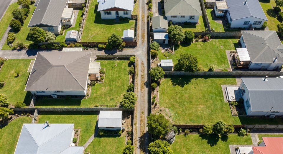Aerial view of New Zealand residential properties showing boundary fences and easement access paths